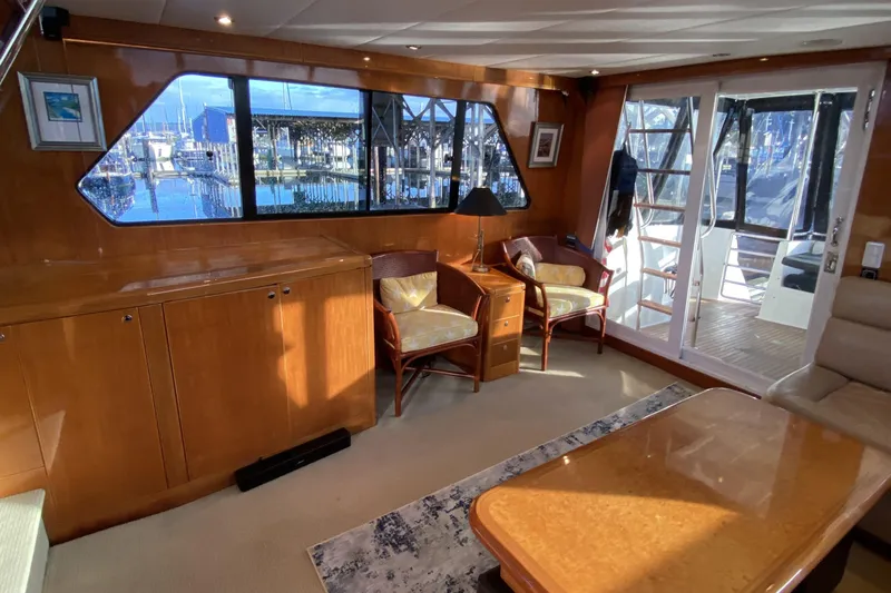 Grey Goose Yacht Photos Pics Luxurious interior of 2000 Compass 55 yacht with elegant wood finishes and marina view.