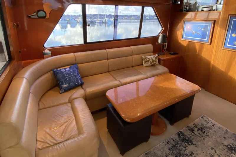 Grey Goose Yacht Photos Pics Luxurious interior of 2000 Compass 55 yacht with leather seating and scenic window view.
