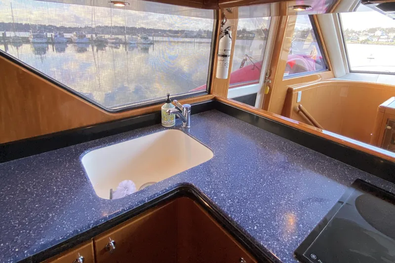 Grey Goose Yacht Photos Pics Luxurious kitchen area on a 2000 Compass 55 yacht with marina view.