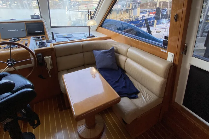 Grey Goose Yacht Photos Pics Luxurious interior of 2000 Compass 55 yacht with leather seating and navigation equipment.