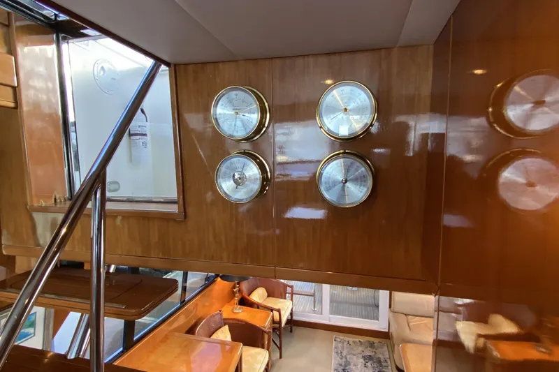Grey Goose Yacht Photos Pics Interior of a 2000 Compass 55 yacht with wooden paneling and nautical instruments.