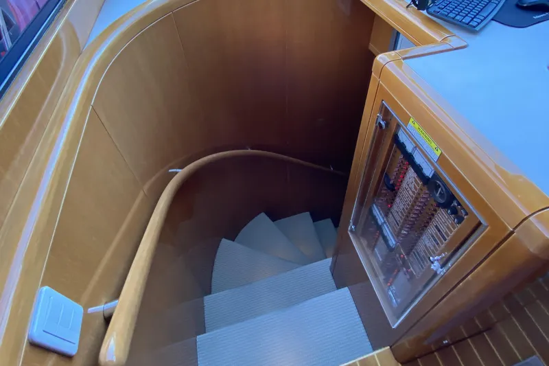 Grey Goose Yacht Photos Pics Wooden staircase with handrail and control panel on a Compass 55 yacht, year 2000.