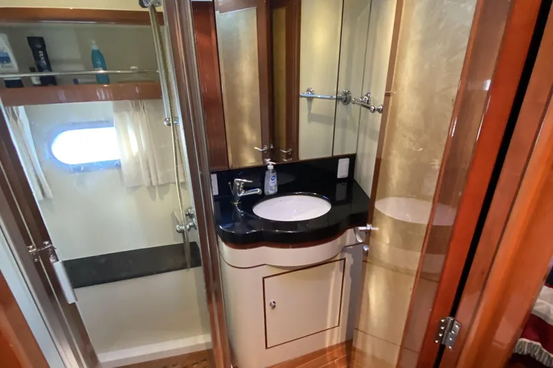 Grey Goose Yacht Photos Pics Luxurious bathroom in 2000 Compass 55 yacht with modern fixtures and elegant design.
