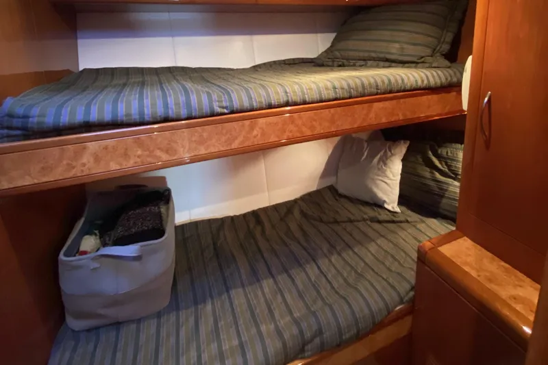 Grey Goose Yacht Photos Pics Compact cabin with wooden bunk beds in a 2000 Compass 55 model.