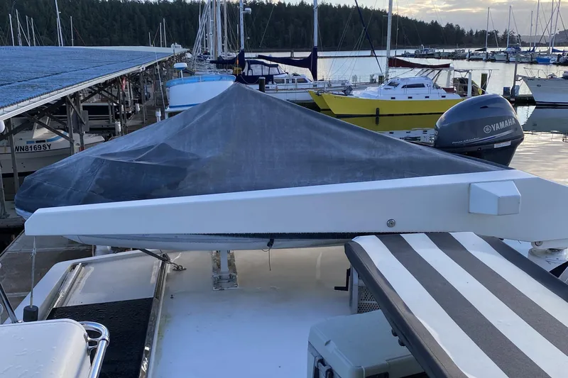 Grey Goose Yacht Photos Pics Boat docked at marina with covered Compass 55, year 2000, and Yamaha motor.