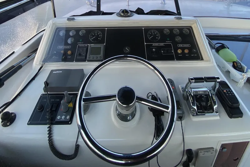 Grey Goose Yacht Photos Pics Boat control panel of a 2000 Compass 55 with steering wheel and navigation instruments.