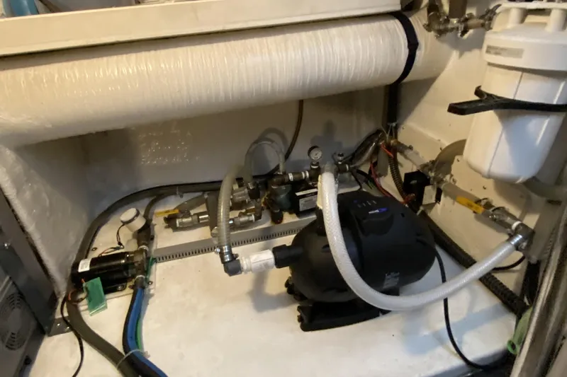 Grey Goose Yacht Photos Pics Engine room of a 2000 Compass 55 boat with various mechanical components.