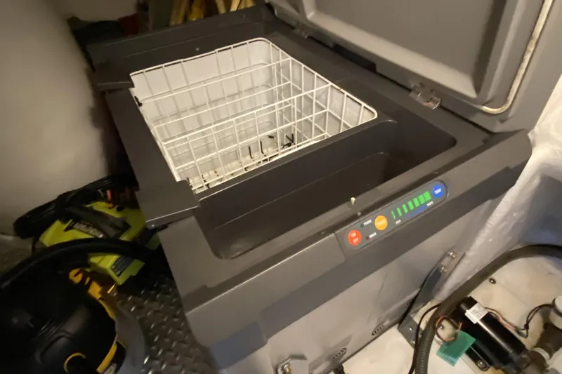 Grey Goose Yacht Photos Pics Open Compass 55 cooler with control panel, year 2000 model, in a storage area.