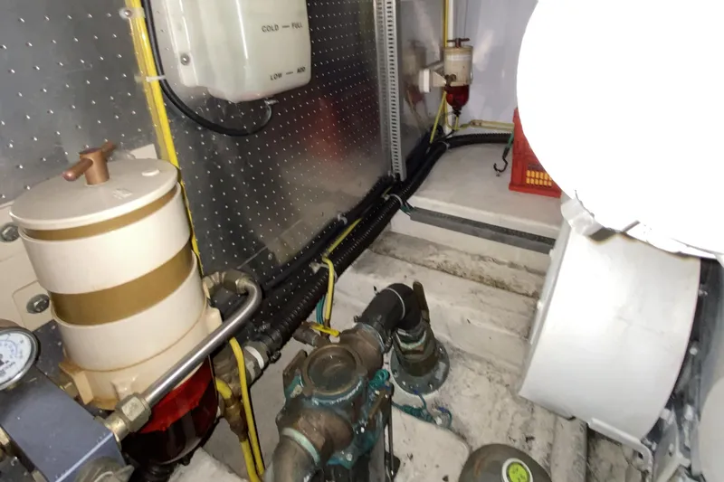 Grey Goose Yacht Photos Pics Engine room of a 2000 Compass 55 boat, featuring mechanical components and wiring.