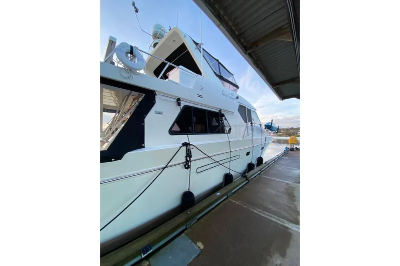 Grey Goose Yacht Photos Pics Luxury Compass 55 yacht docked, 2000 model, featuring sleek design and modern amenities.