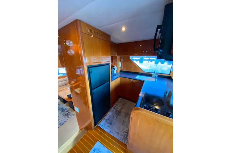 Grey Goose Yacht Photos Pics Luxurious kitchen interior of 2000 Compass 55 yacht with modern appliances and wood finish.