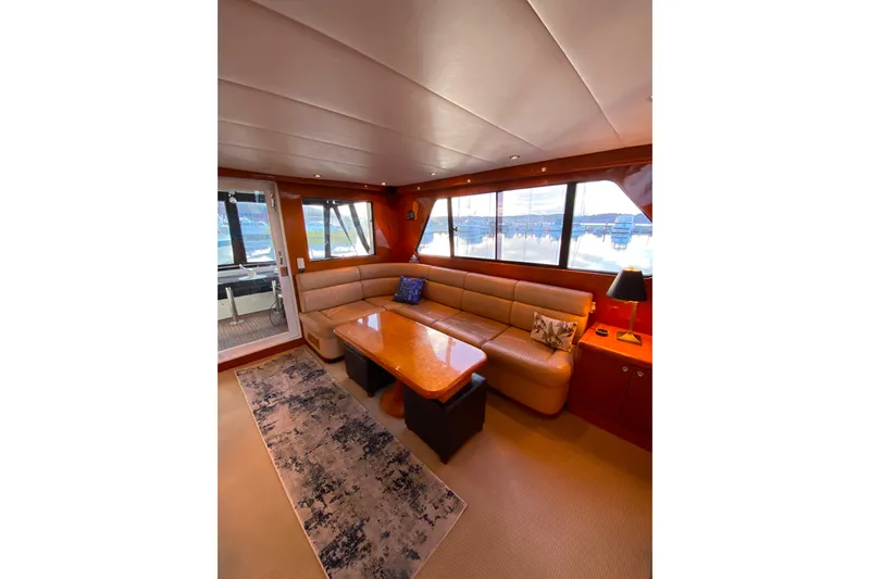 Grey Goose Yacht Photos Pics Luxurious interior of 2000 Compass 55 yacht with plush seating and elegant decor.