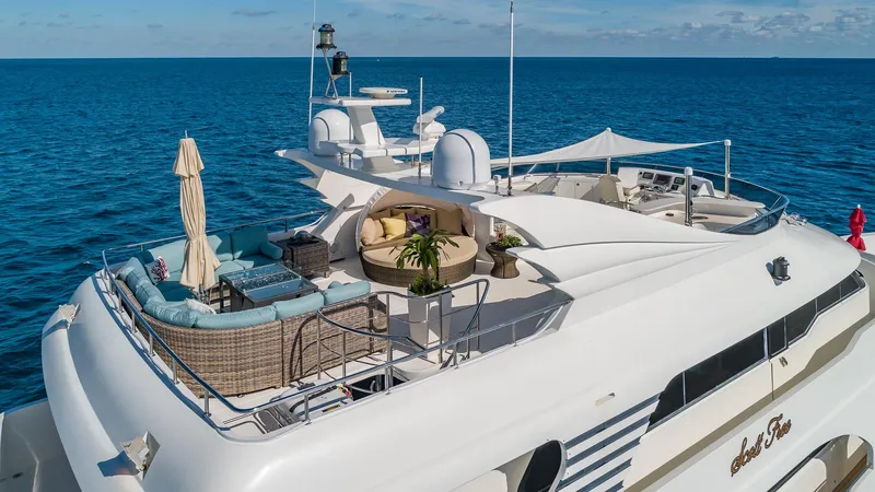 Scott Free Yacht Photos Pics Luxurious 2008 President Tri-Deck yacht with elegant outdoor seating on the ocean.