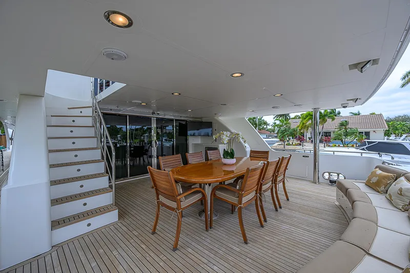 Scott Free Yacht Photos Pics Luxurious 2008 President Tri-Deck yacht with elegant outdoor dining area and seating.