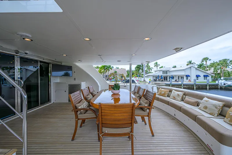 Scott Free Yacht Photos Pics Luxurious 2008 President Tri-Deck yacht deck with elegant seating and dining area.