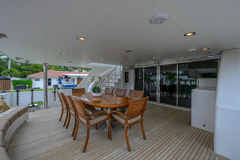 Scott Free Yacht Photos Pics Luxurious 2008 President Tri-Deck yacht with elegant outdoor dining area.