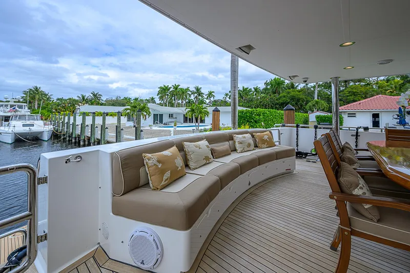 Scott Free Yacht Photos Pics Luxurious 2008 President Tri-Deck yacht with elegant outdoor seating and scenic marina view.