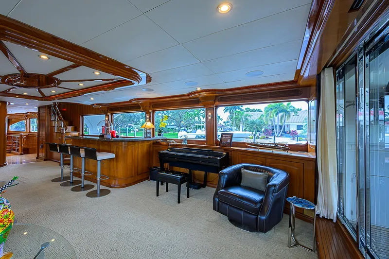 Scott Free Yacht Photos Pics Luxurious 2008 President Tri-Deck yacht interior with bar, piano, and seating area.