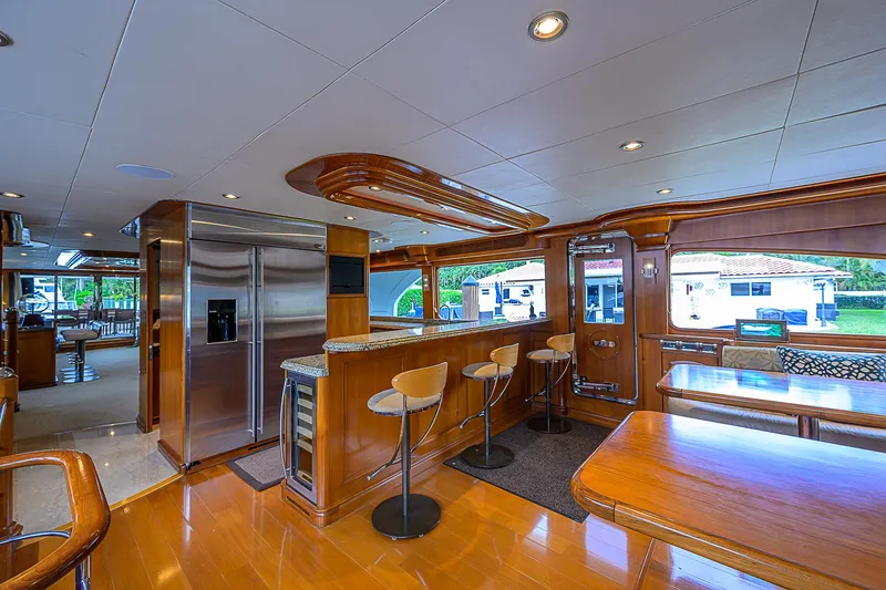 Scott Free Yacht Photos Pics Luxurious 2008 President Tri-Deck yacht interior with modern kitchen and bar area.