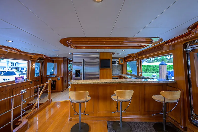 Scott Free Yacht Photos Pics Luxurious 2008 President Tri-Deck yacht interior with modern kitchen and bar seating.
