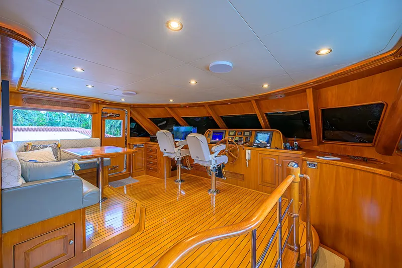 Scott Free Yacht Photos Pics Luxurious 2008 President Tri-Deck yacht interior with wood finish and modern navigation equipment.