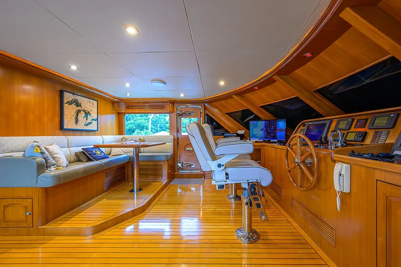 Scott Free Yacht Photos Pics Luxurious 2008 President Tri-Deck yacht interior with wooden helm and seating area.