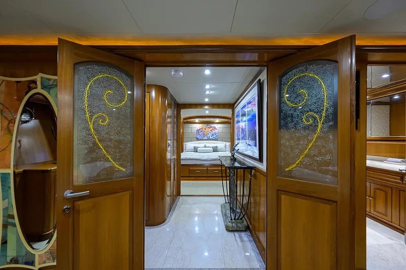 Scott Free Yacht Photos Pics Luxurious interior of 2008 President Tri-Deck yacht with elegant wood and glass doors.