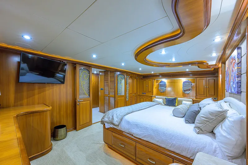 Scott Free Yacht Photos Pics Luxurious 2008 President Tri-Deck yacht bedroom with elegant wood paneling and modern amenities.