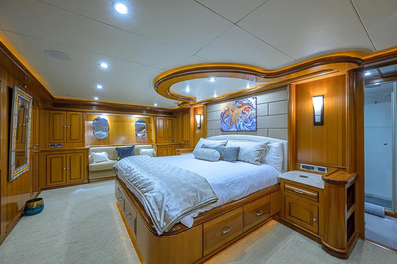 Scott Free Yacht Photos Pics Luxurious 2008 President Tri-Deck yacht bedroom with elegant wood paneling and modern lighting.