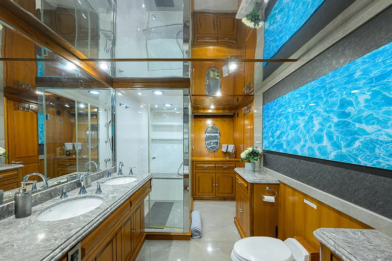Scott Free Yacht Photos Pics Luxurious yacht bathroom with wood cabinetry, marble countertops, and modern fixtures, 2008 President Tri-Deck.