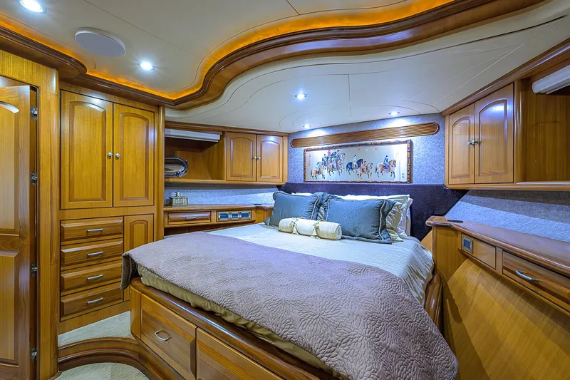 Scott Free Yacht Photos Pics Luxurious 2008 President Tri-Deck yacht bedroom with elegant wood cabinetry and ambient lighting.