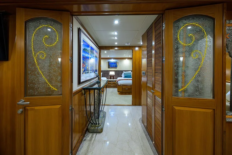 Scott Free Yacht Photos Pics Luxurious interior of 2008 President Tri-Deck yacht with elegant wood and glass doors.
