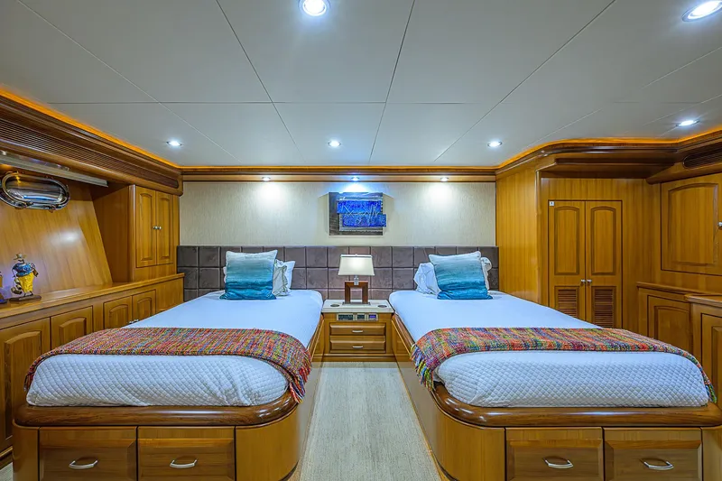 Scott Free Yacht Photos Pics Luxurious twin bedroom on 2008 President Tri-Deck yacht with elegant wood finishes.