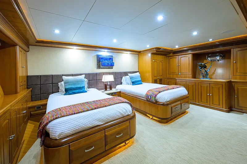 Scott Free Yacht Photos Pics Luxurious twin bedroom on 2008 President Tri-Deck yacht with elegant wood furnishings.