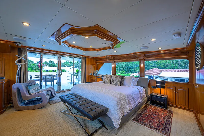 Scott Free Yacht Photos Pics Luxurious 2008 President Tri-Deck yacht bedroom with elegant decor and outdoor view.