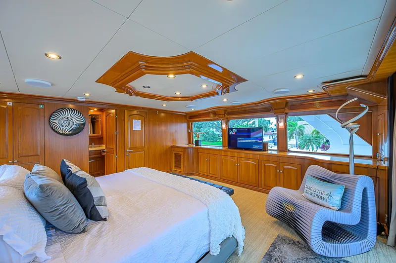Scott Free Yacht Photos Pics Luxurious 2008 President Tri-Deck yacht bedroom with elegant wood paneling and modern decor.