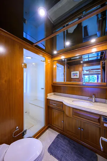 Scott Free Yacht Photos Pics Luxurious bathroom in 2008 President Tri-Deck yacht with wood cabinetry and modern fixtures.