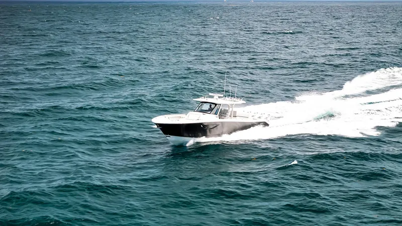 All Jack'd Up Yacht Photos Pics 2023 Pursuit S 428 Sport boat cruising on open ocean waters.