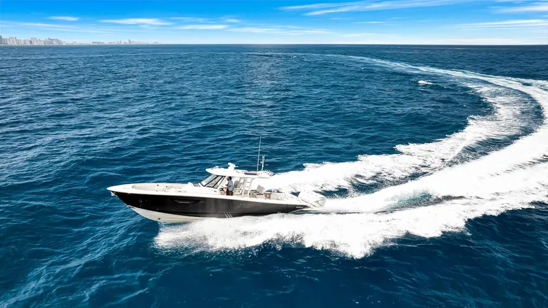 All Jack'd Up Yacht Photos Pics 2023 Pursuit S 428 Sport boat cruising on open ocean waters.