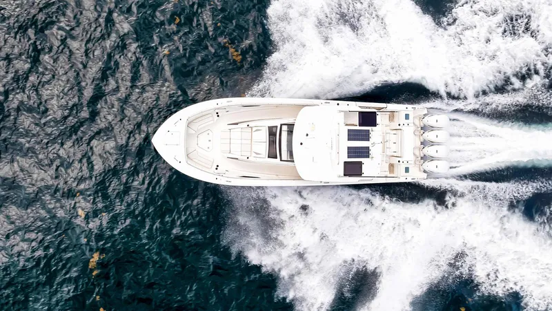 All Jack'd Up Yacht Photos Pics Aerial view of 2023 Pursuit S 428 Sport boat speeding on ocean waters.