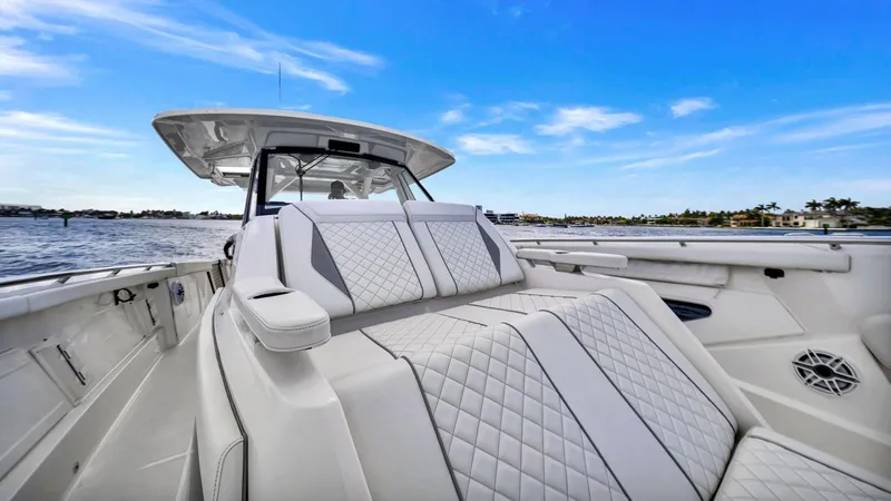 All Jack'd Up Yacht Photos Pics 2023 Pursuit S 428 Sport boat with luxurious seating on a sunny day.