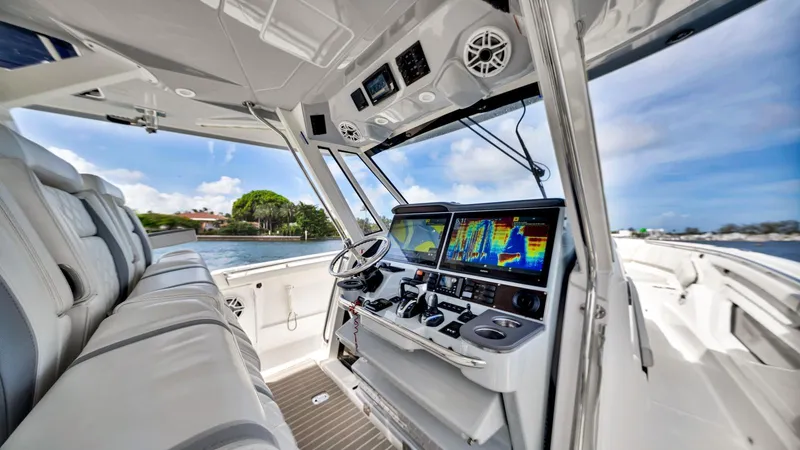All Jack'd Up Yacht Photos Pics 2023 Pursuit S 428 Sport boat interior with advanced navigation displays and luxurious seating.
