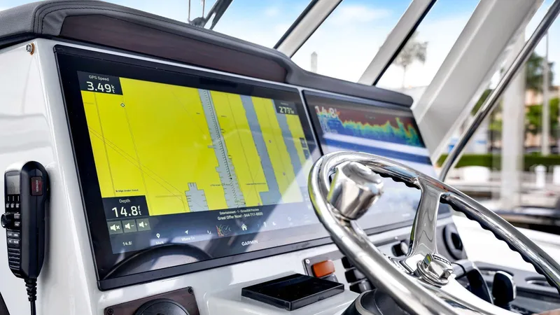 All Jack'd Up Yacht Photos Pics Helm of 2023 Pursuit S 428 Sport boat with navigation display and steering wheel.