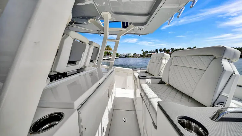 All Jack'd Up Yacht Photos Pics 2023 Pursuit S 428 Sport boat interior with luxurious seating and sleek design on a sunny day.