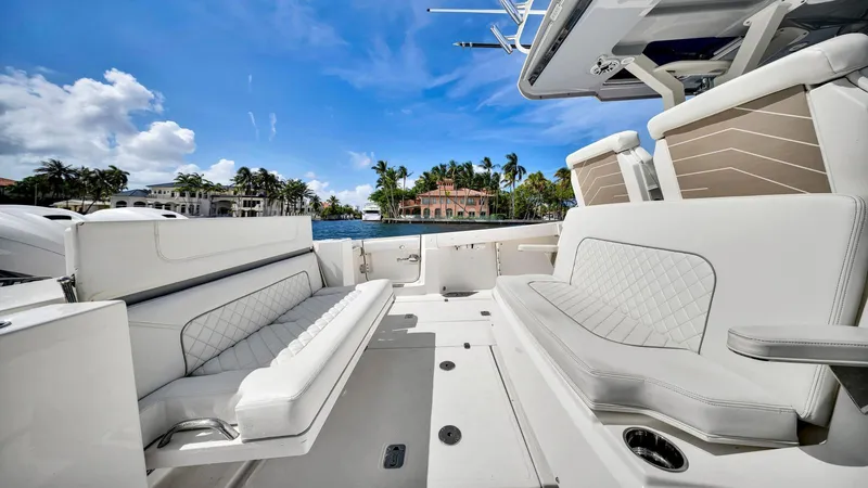 All Jack'd Up Yacht Photos Pics 2023 Pursuit S 428 Sport boat interior with luxurious seating and waterfront view.