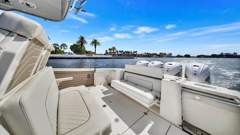 All Jack'd Up Yacht Photos Pics 2023 Pursuit S 428 Sport boat interior with luxurious seating and multiple outboard engines.