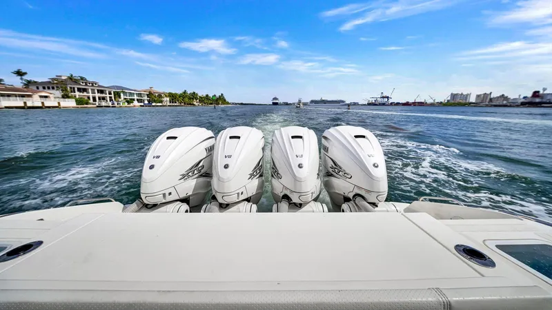 All Jack'd Up Yacht Photos Pics 2023 Pursuit S 428 Sport boat with four powerful outboard engines on the water.