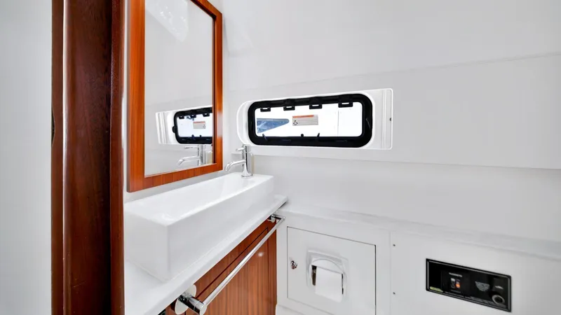 All Jack'd Up Yacht Photos Pics 2023 Pursuit S 428 Sport boat interior bathroom with sink and mirror.