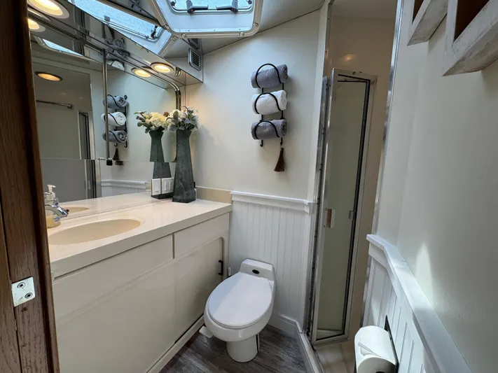 Negotiator Yacht Photos Pics Bathroom interior of 1994 Hatteras 54 Convertible yacht, featuring modern fixtures and elegant decor.
