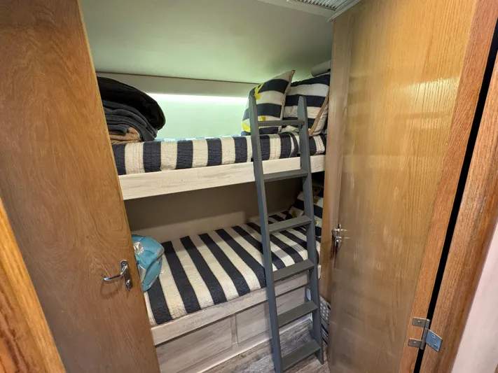 Negotiator Yacht Photos Pics Bunk beds with striped bedding in 1994 Hatteras 54 Convertible yacht cabin.